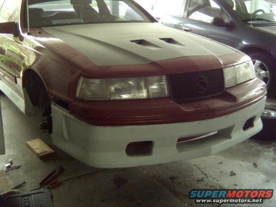 1988 Mercury Cougar front bumper and grille, red and white body, hood scoops