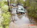 1995 Dodge 1500 - A group of off-road vehicles navigate a water obstacle, with one Jeep Cherokee XJ partially submerged.