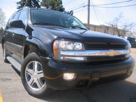 Black SUV with chrome grille and headlights. Tire has 'CONTINENTAL' text
