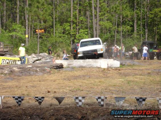 White pickup truck navigating an obstacle course