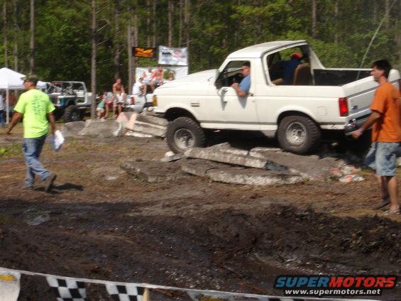 White 1989 Ford Bronco on obstacle course