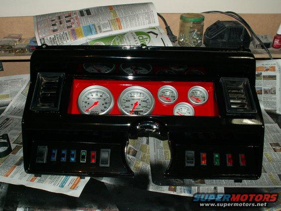 the dash mocked up for looks....still clearcoat to go....mount gauges properly in a weeks time once paint hardened properly....new airvents yet to cometo finish it off.