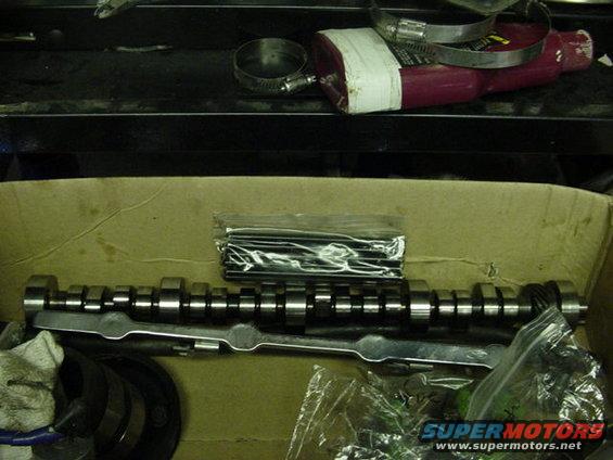 Camshaft and assorted engine parts in a box