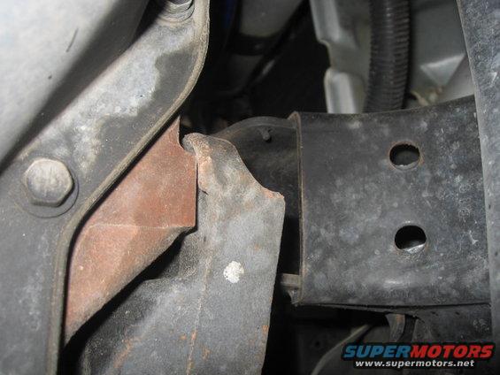 Engine mount bracket with rust and bolt detail