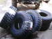 1979 Ford Bronco - A collection of new, off-road tires are ready for installation on a vehicle.