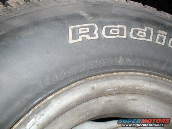Tire with raised white lettering reading "Radial" and size LT265/75R16