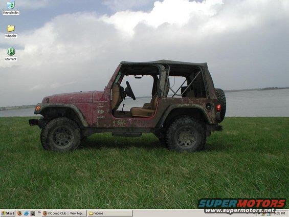 1998 Jeep TJ parked on grass with water in the background