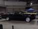 1968 Ford Ranchero - A black 1968 Ford Ranchero is displayed indoors, with another vehicle visible to its right.