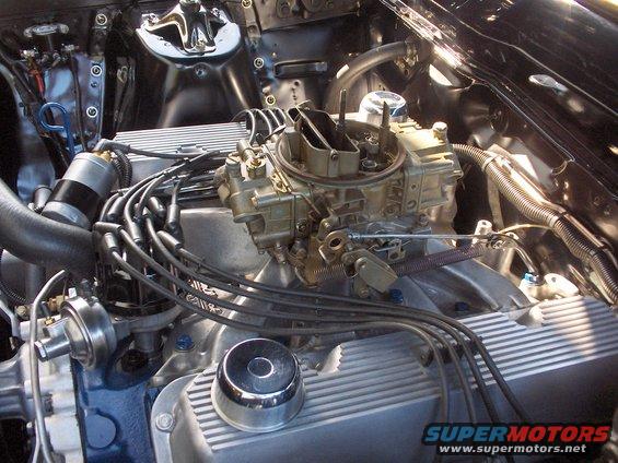 Close-up of a V8 engine's carburetor and spark plug wires
