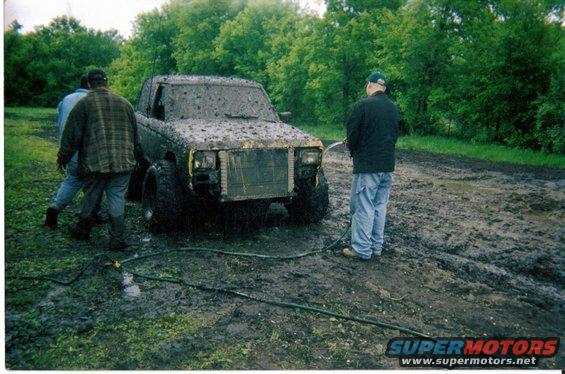 Mud-covered 1987 Ford Bronco II front view being washed