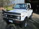 1987 Suzuki Samurai - This 1987 Suzuki Samurai features KC lights mounted on the windshield frame and a custom grille with 'ZUK' badging.