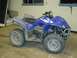 2006 Yamaha WOLVERINE - This blue ATV is covered in dust and dirt, suggesting it has been used off-road.