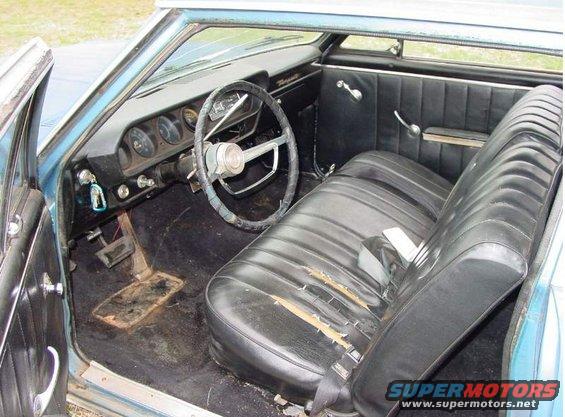 1964 Pontiac Tempest interior, blue exterior, black seats with tears, dashboard with gauges