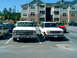 1993 Ford Explorer - A white 1993 Ford Explorer is parked in a lot next to a classic pickup truck.