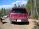1991 Ford Explorer - Rear view of a red 1991 Ford Explorer parked outdoors with a white car in the background.