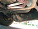 1993 Ford Explorer - A view of the undercarriage, showing suspension and exhaust parts.