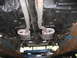1978 Dodge Monaco - Undercarriage view shows a dual exhaust system with two oval mufflers and visible suspension components.