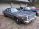 1978 Dodge Monaco - This 1978 Dodge Monaco is parked in front of a garage, with two other sedans visible behind it.