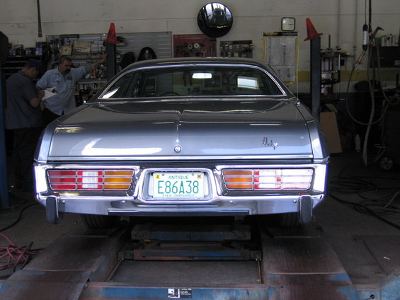 Rear view of a 1978 Dodge Monaco on a lift in a garage