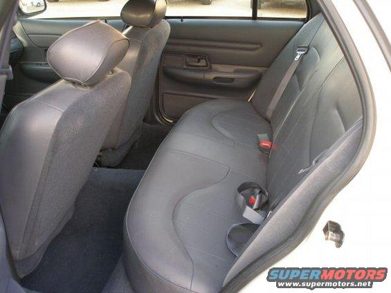 2001 Ford Crown Victoria interior, gray seats, rear bench seat, door panel visible