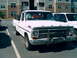 1969 Ford F-100 - A white 1969 Ford F-100 pickup truck is parked in a lot next to another white vehicle.