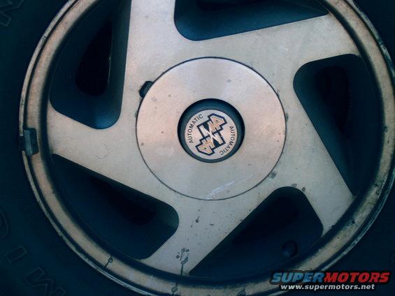 Close-up of a wheel with a center cap that reads 'AUTOMATIC 4x4 AUTOMATIC'