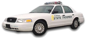 White Kansas State Trooper car, likely a 2001 Ford Crown Victoria, with light bar on top