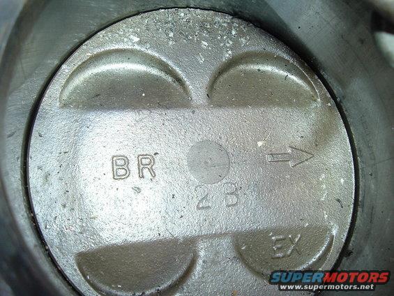 Piston top showing 'BR', '2B', 'EX', and an arrow