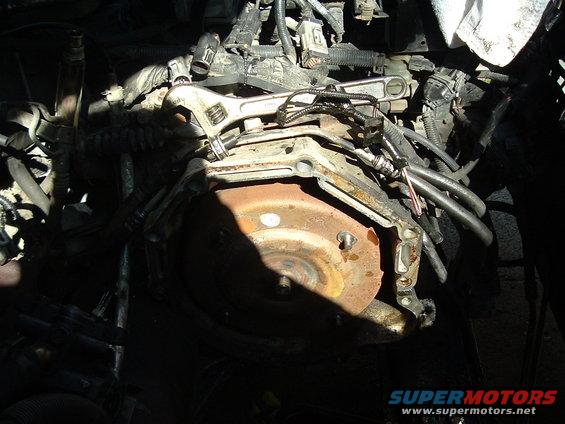 Rusty torque converter and transmission housing with adjustable wrench on engine components