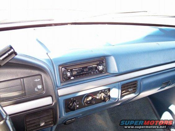 Blue dashboard interior with Pioneer radio, air vents, and climate controls. Some wear visible