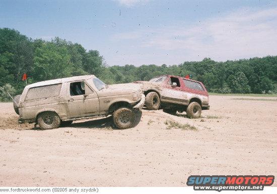 Tan Ford Bronco with mud, side view, off-road