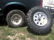 1996 Ford Bronco - A 1996 Ford Bronco is shown with one of its large off-road tires mounted and another next to it.