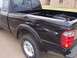 2003 Ford Ranger - This black Ford Ranger pickup truck shows extensive damage to its side and rear, indicating it has been in a wreck.