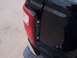 2003 Ford Ranger - Close-up of a damaged black pickup truck taillight assembly, revealing broken plastic and exposed components.