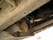 1991 Ford Explorer - Close-up view of the undercarriage of a vehicle, showing rusty parts and exhaust system.