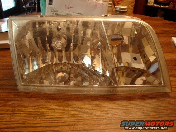 Headlight assembly with visible text markings on the bottom edge