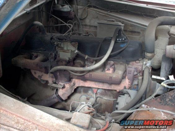 Engine bay with V8 engine, carburetor, and hoses