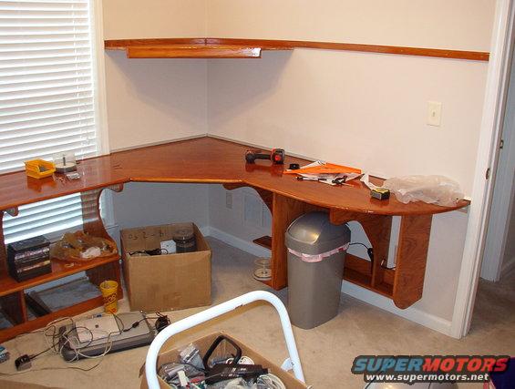 93myshelf.jpg Because of a consideration on her side, I'm putting the shelf support rail ABOVE the upper shelf on both sides.  I'm just test-fitting my corner here.