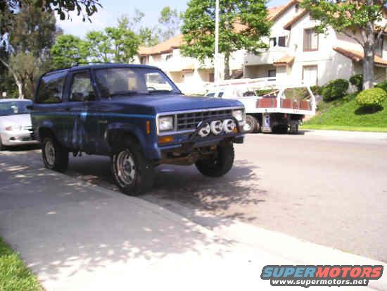 Blue 1987 Ford Bronco II parked on street with aftermarket lights