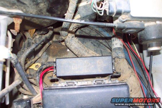 dcp_0902.jpg Ignition On Signal
The ignition on signal source is obtained from trailer battery charge relay.  Connection is made by taping into the wire from underneath the auxiliary relay box.  The small red wire is the ignition on signal for the electric cooling fan.  The larger red wire is battery charge relay output going to power rock lights and air compressor.
(4/29/2006)