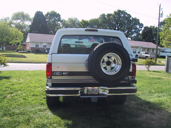 1994 Ford Bronco rear view, silver and white, with spare tire mounted on the back