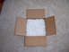 1996 Ford Bronco - A box of packing peanuts sits on a carpet, with the Supermotors logo visible.