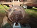 1988 Ford Bronco - Close-up view of a vehicle's rear drum brake assembly, supported by jack stands.
