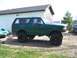 1996 Ford Bronco - This lifted 1996 Ford Bronco is parked on gravel next to a building.