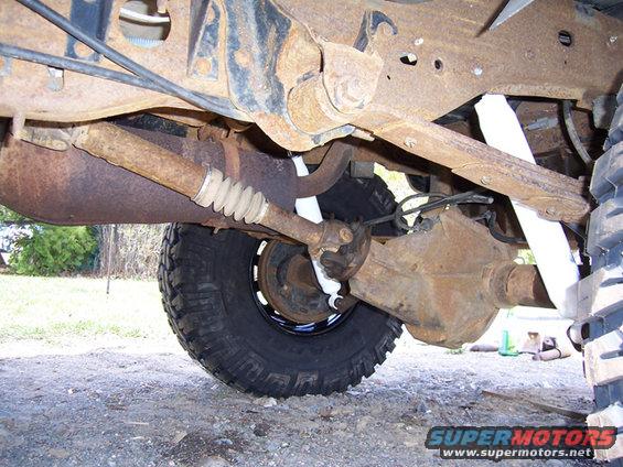 Undercarriage view of a lifted truck's rear axle and driveshaft
