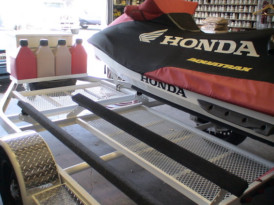 Jet ski cover with HONDA AQUATRAX text on a trailer
