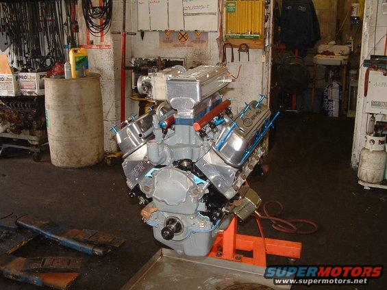 Engine on an orange stand in a garage