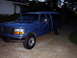 1995 Ford Bronco - This blue 1995 Ford Bronco is equipped with a camper shell and seen from a 3q front angle.