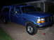 1995 Ford Bronco - This blue pickup truck with a camper shell appears to be from the early to mid-1990s, not a 1995 Bronco.