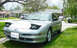 1993 Ford Probe - This 1993 Ford Probe features pop-up headlights and a distinctive coupe body style, seen here parked in a suburban setting.